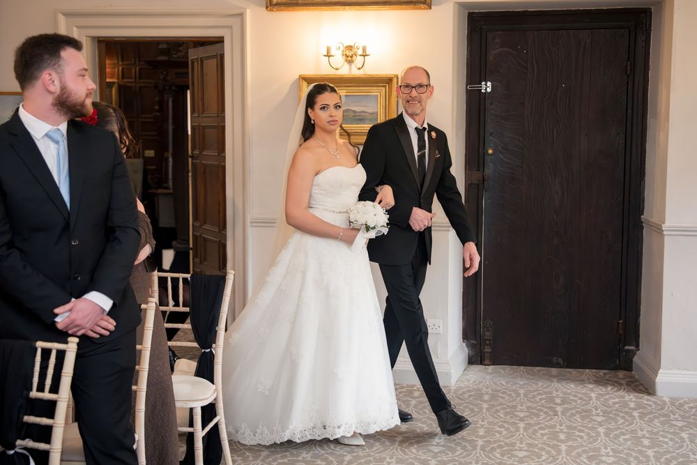 A sequence of wedding photos showing a couple entering a doorway in a formal venue.