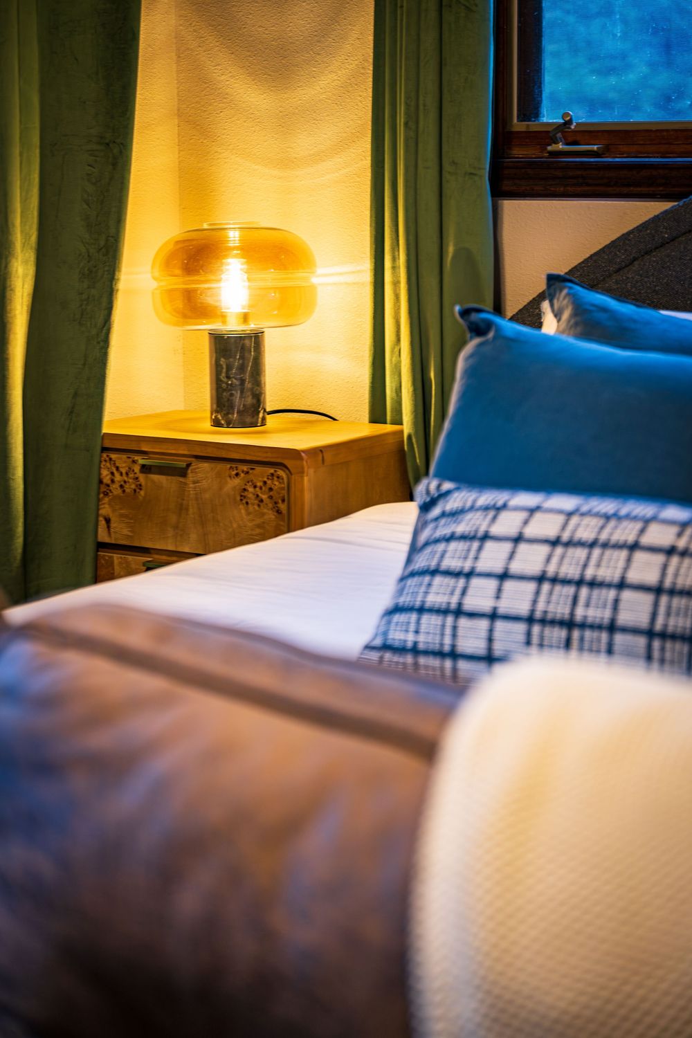A warm, cozy bedroom with soothing lighting by Denver Hospitality, Travel & Tourism photographer Captain Colorado Photography.