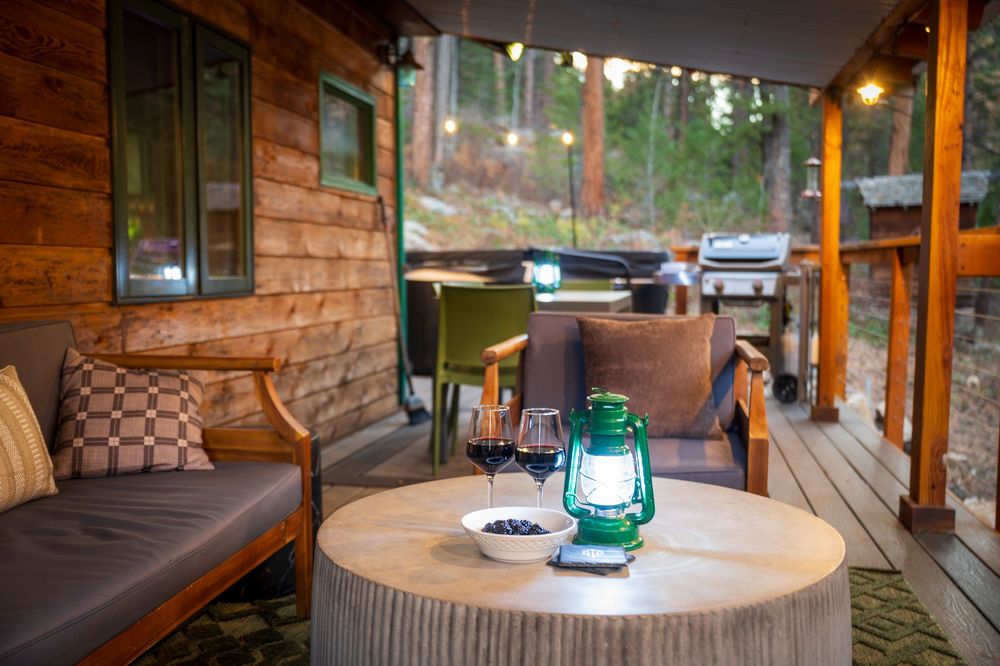 Front deck patio with lantern and wine by Denver Hospitality, Travel & Tourism photographer Captain Colorado Photography.
