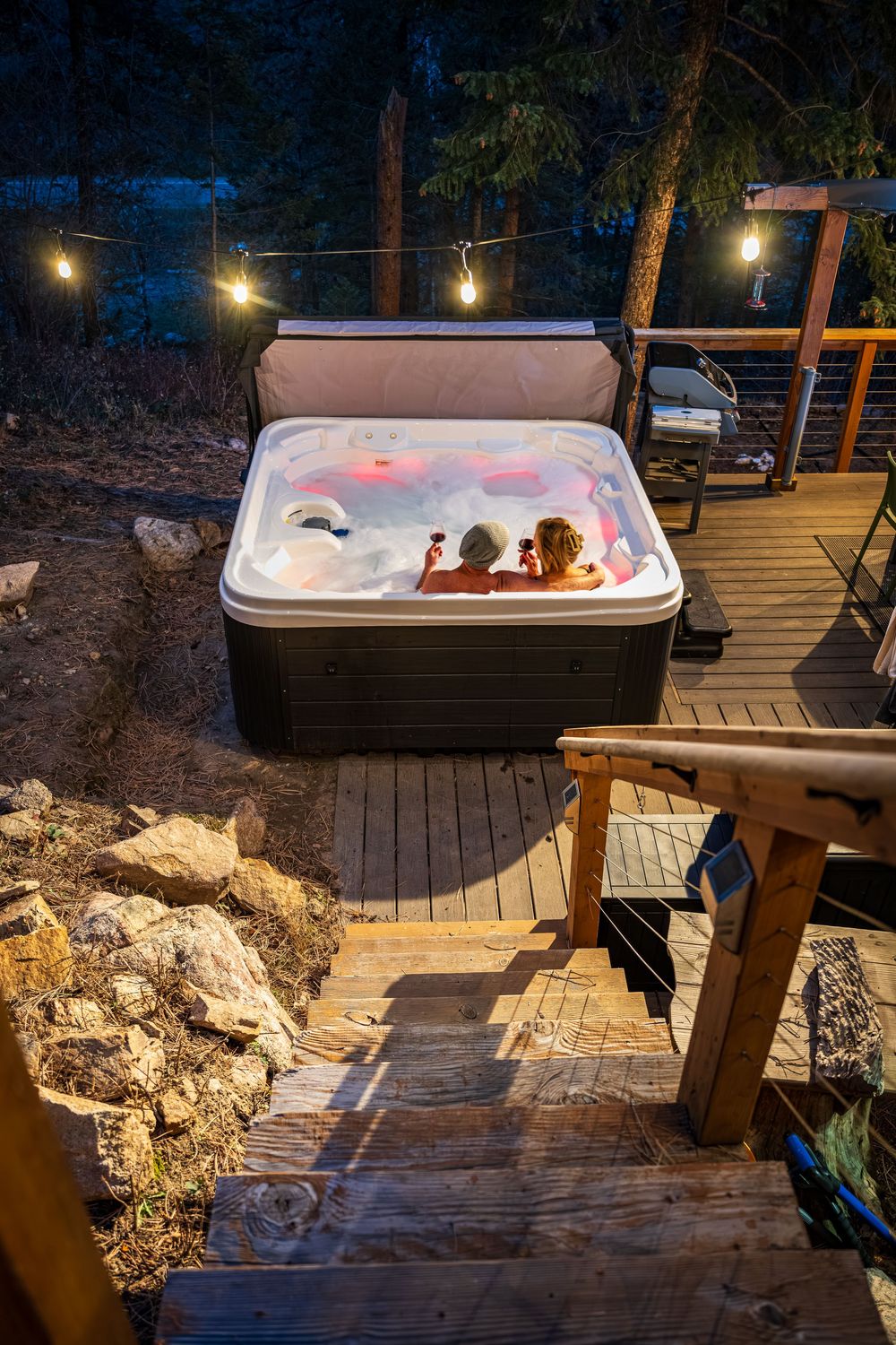 A couple enjoying wine in the hot tub by Denver Hospitality, Travel & Tourism photographer Captain Colorado Photography.