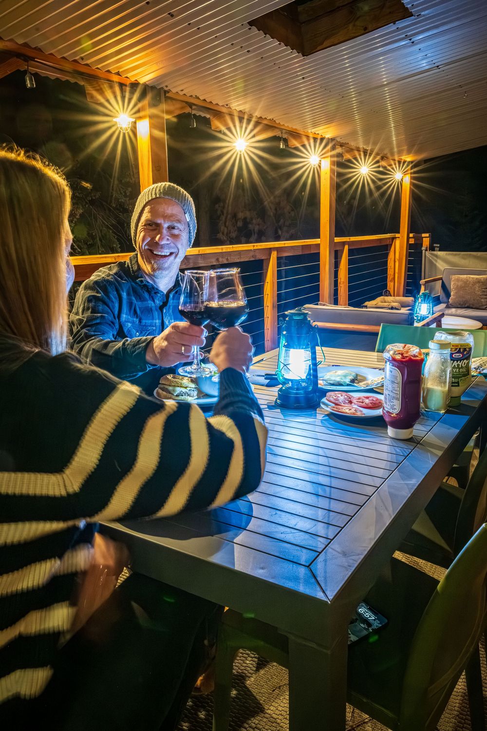 A couple enjoying dinner on the front deck by Denver Hospitality, Travel & Tourism photographer Captain Colorado Photography.