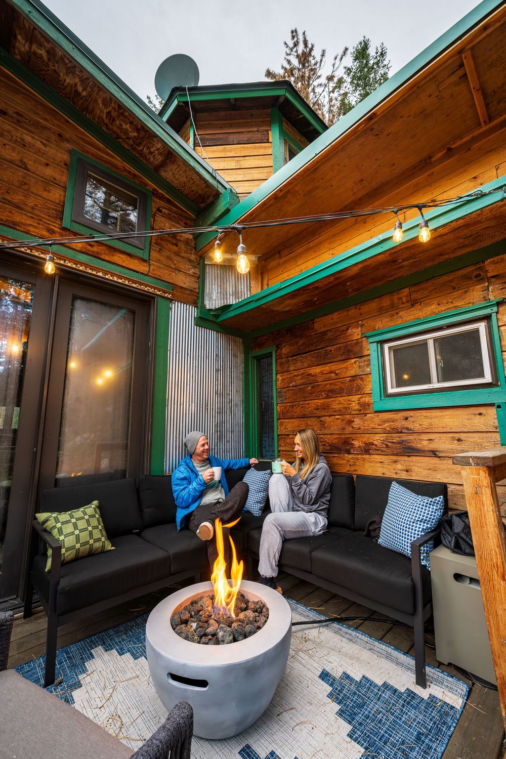 A couple enjoying coffee by the firepit by Denver Hospitality, Travel & Tourism photographer Captain Colorado Photography.