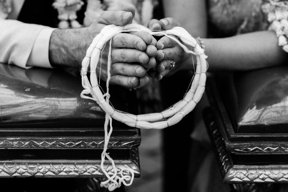 Black and white photo of wedding ceremony tradition of "tying the knot".