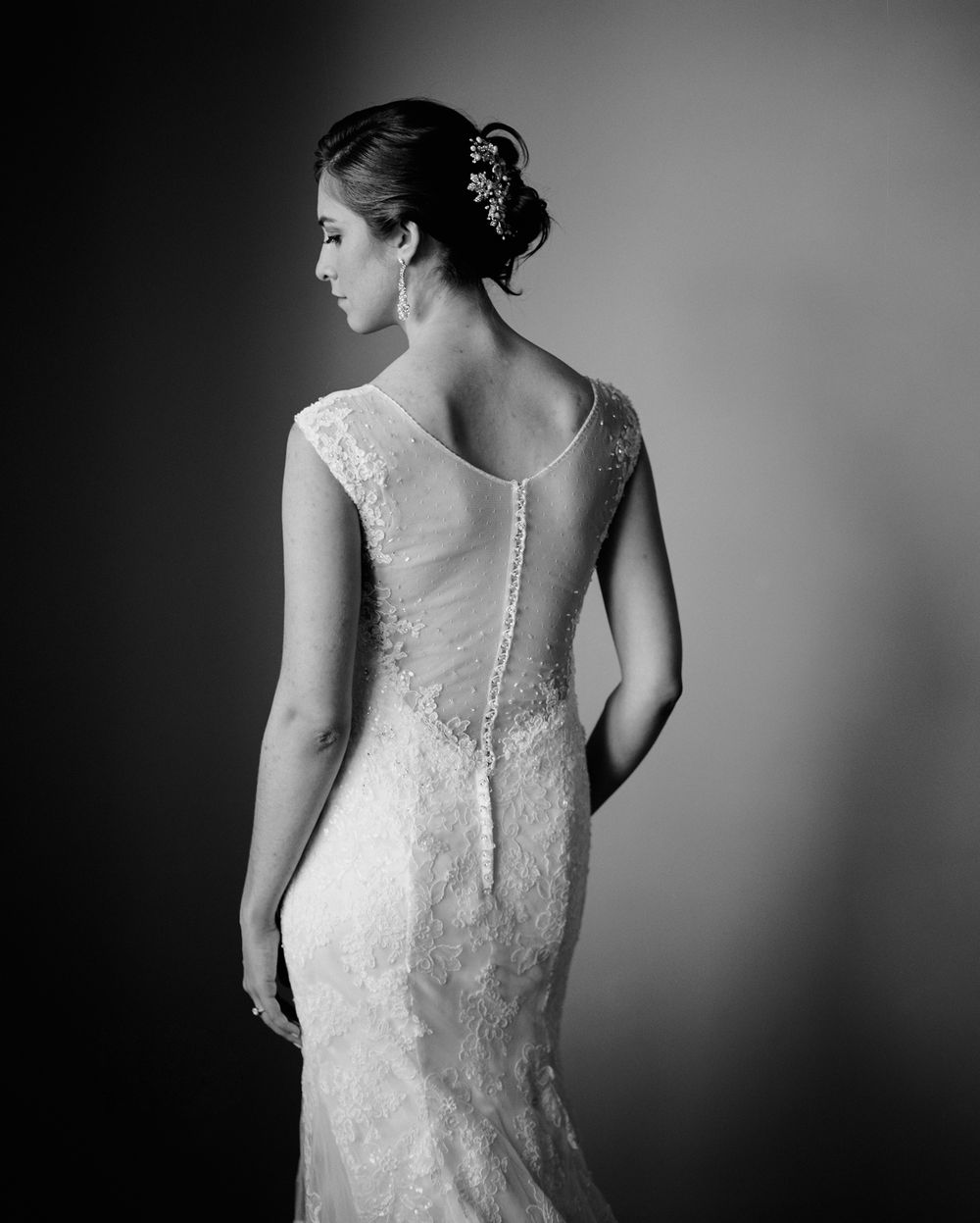 Fine art medium format film portrait of bride and the back of her dress.