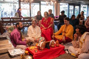 A sequence of traditional Indian wedding ceremony rituals being performed with participants in vibrant red and gold attire.