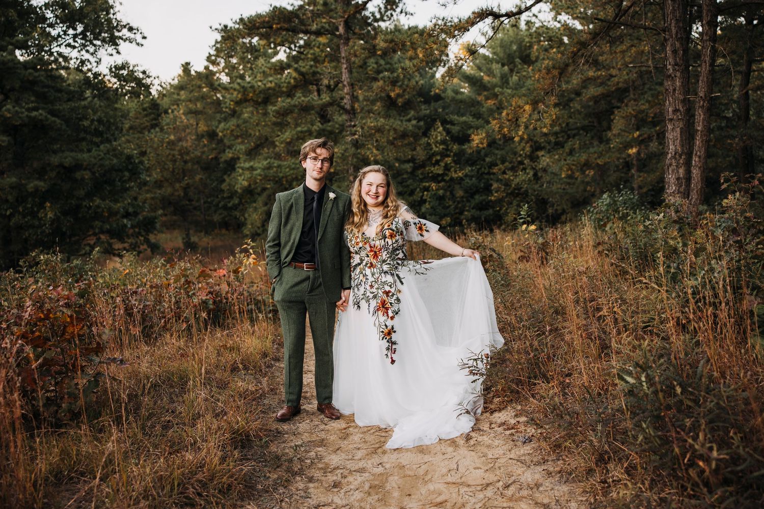 couple eloping in the woods with a whimsical style dress