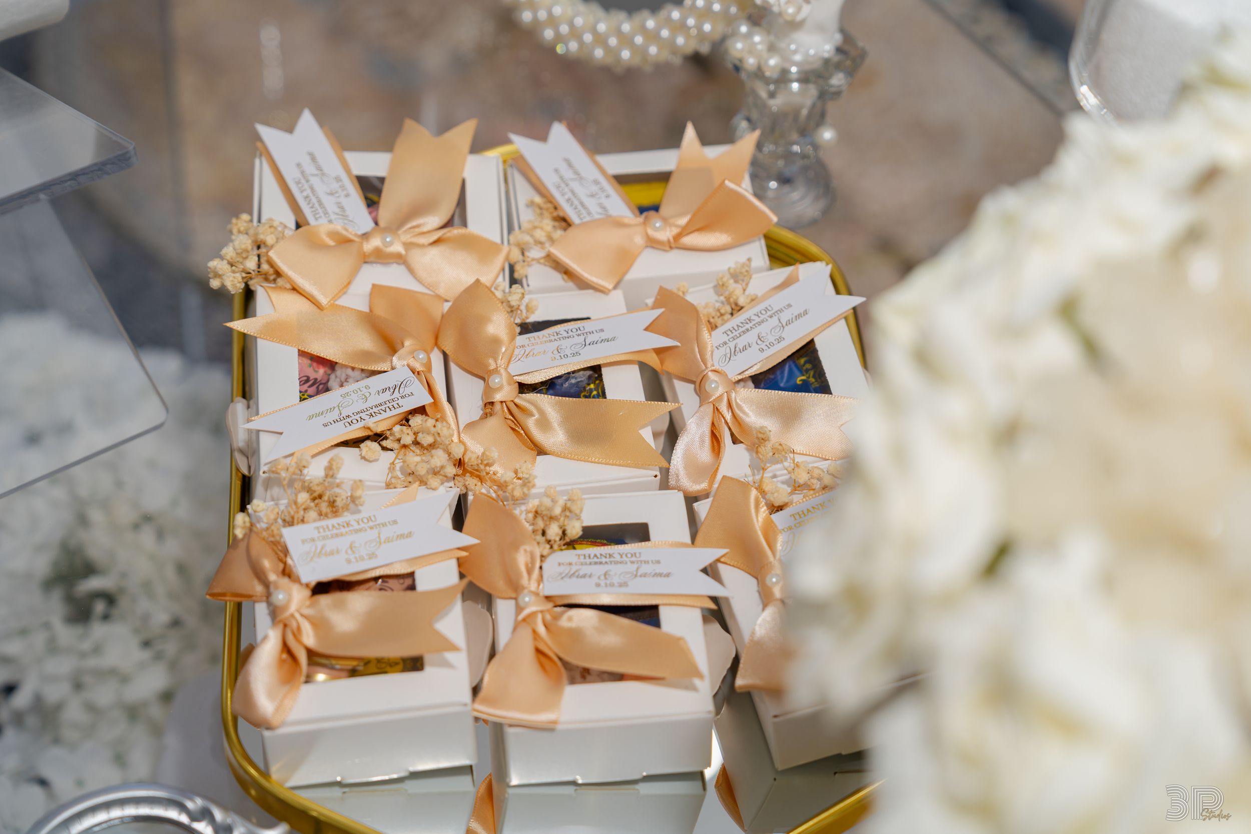 Elegant beige and white wedding shoes arranged in pairs on a textured surface.