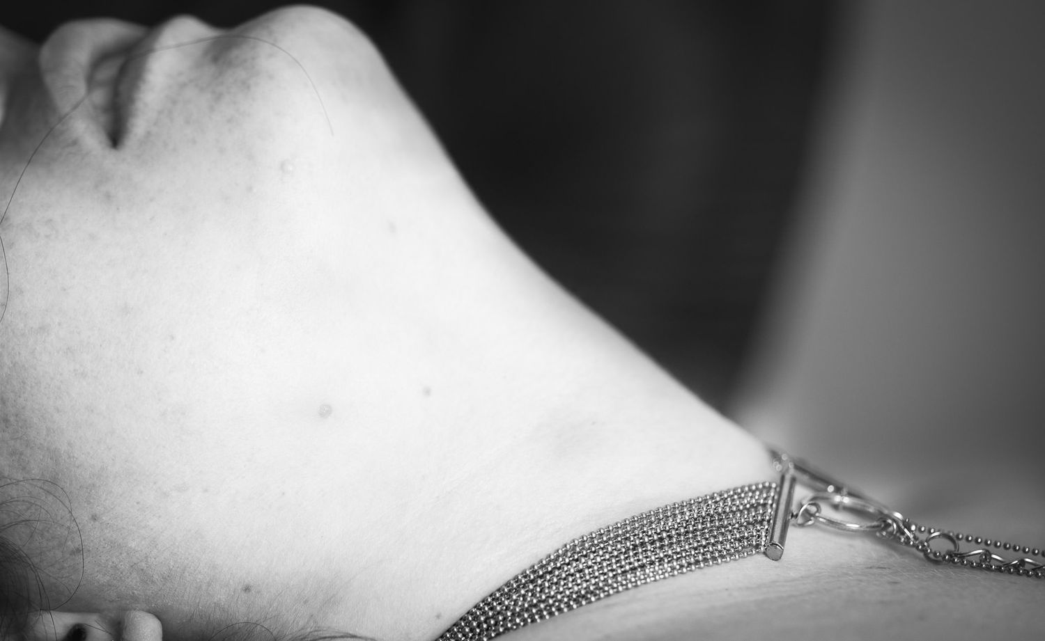 Black and white close-up photographs of jewelry details and necklace clasps arranged in a horizontal strip.