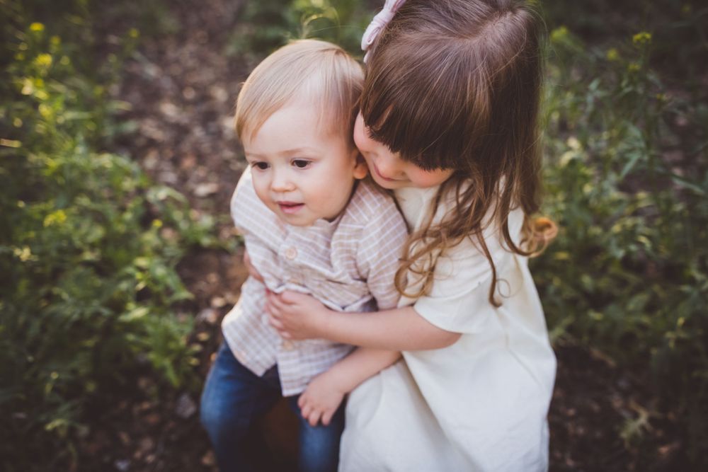 Natural light photography captures emotional connection between mother and child during outdoor session.
