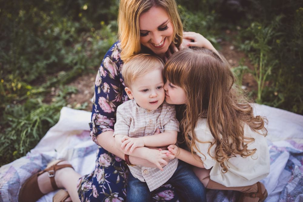 Candid lifestyle photography captures loving moments between parent and child in garden setting.