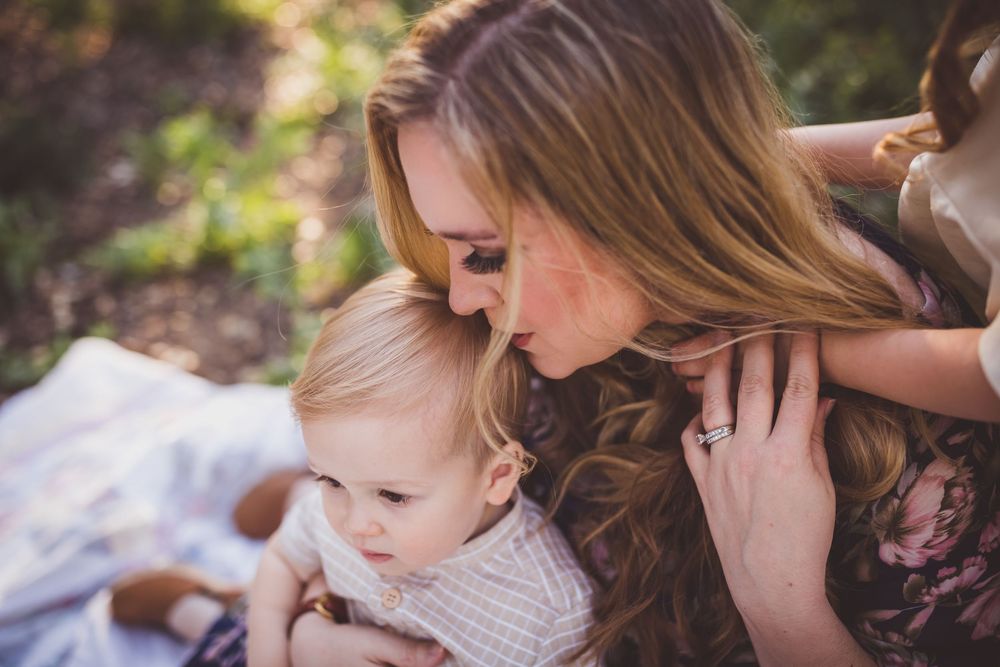 A series of candid outdoor family moments showing affectionate interactions between parent and child in natural lighting.