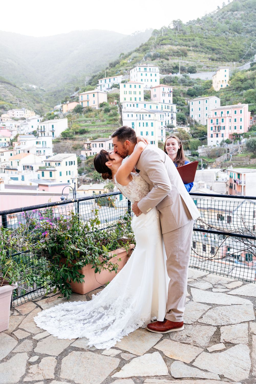 A romantic and intimate elopement wedding  on a terrace overlooking the colorful hillside buildings of Cinque Terre, Italy.