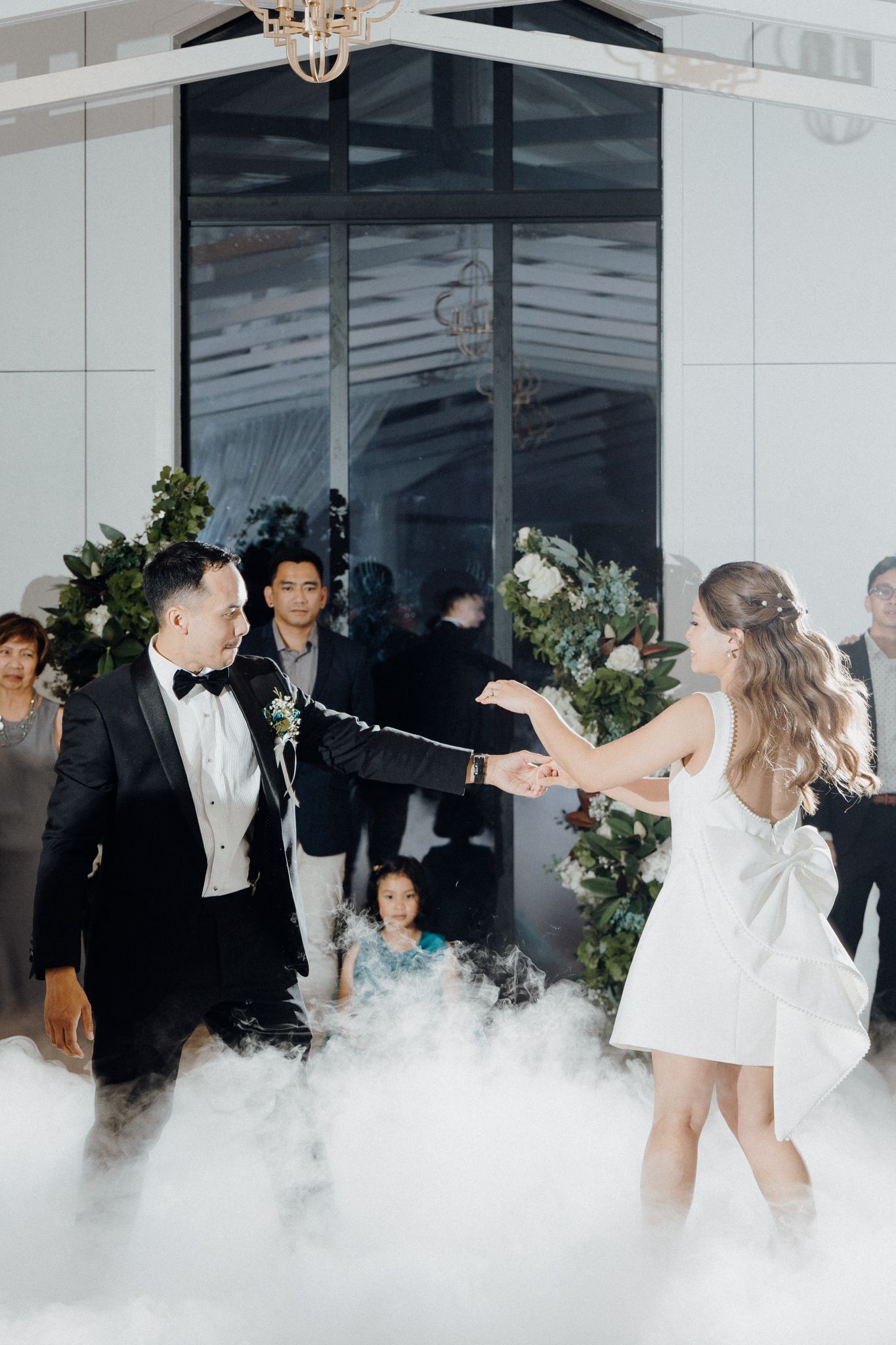 Bride and groom dance at a wedding reception with fog machine captured by Apertured Media Auckland Wedding Photographer.