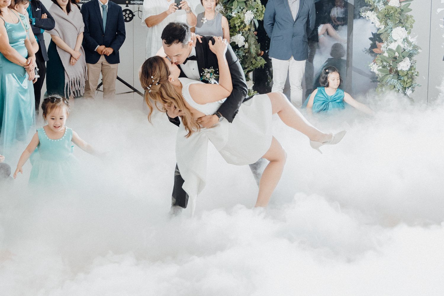 The bride and groom dance together surrounded by atmospheric fog effects captured by Apertured Media Auckland Wedding Photographer..