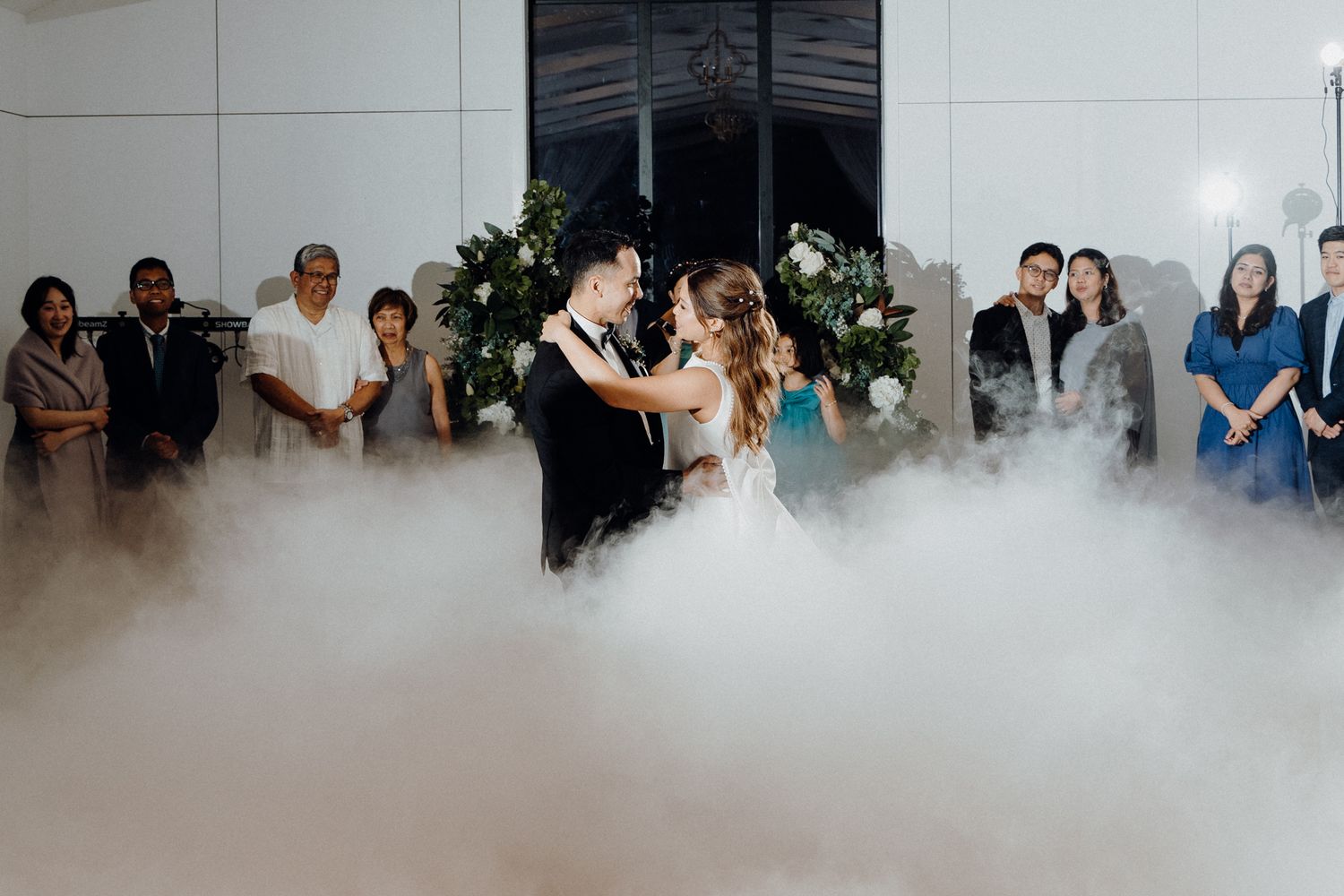 A newly wedd at a wedding reception as fog covers the dance floor captured by Apertured Media Auckland Wedding Photographer.