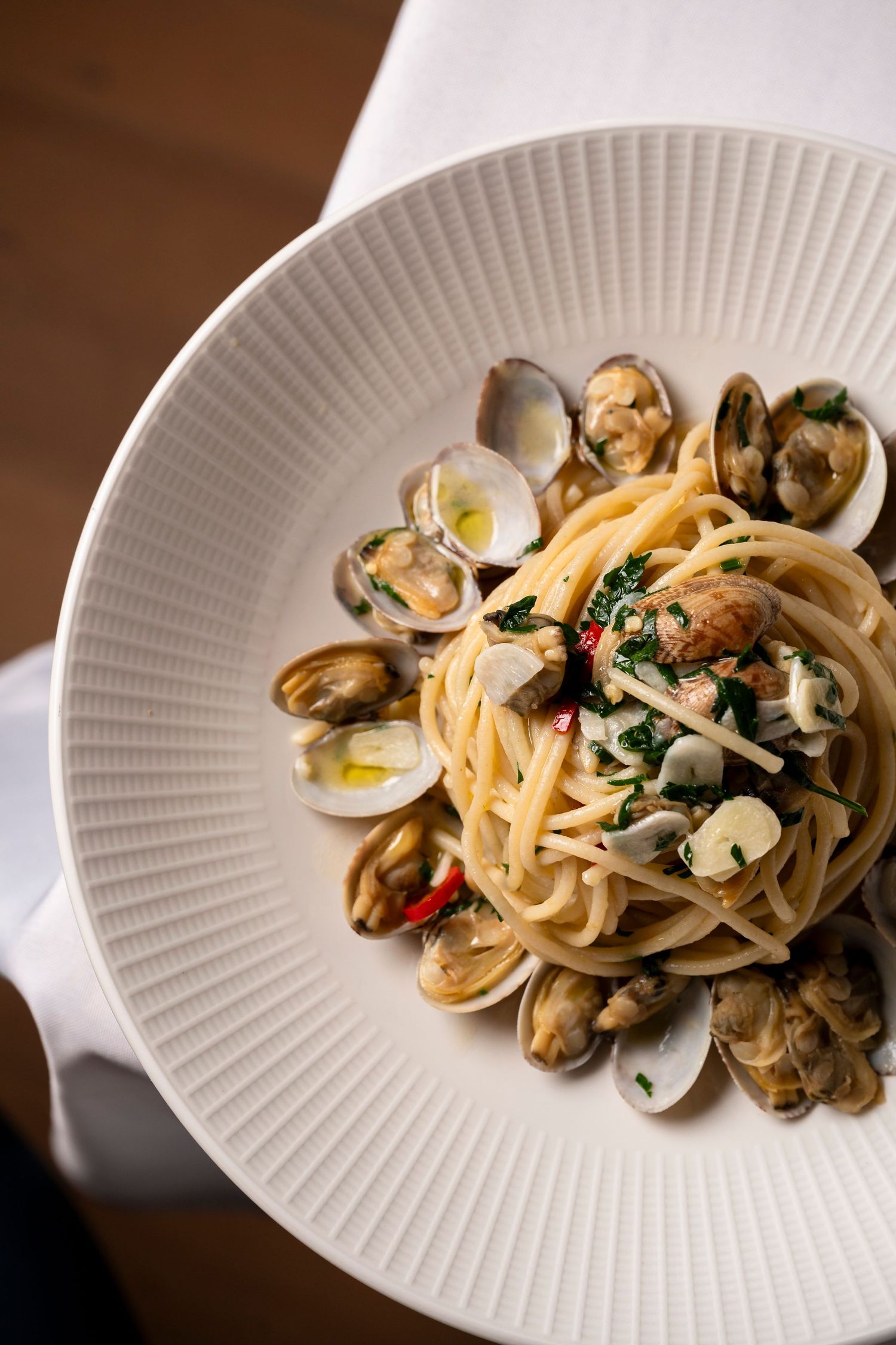 Italian food photography showcasing seafood pasta and contemporary fine dining presentation