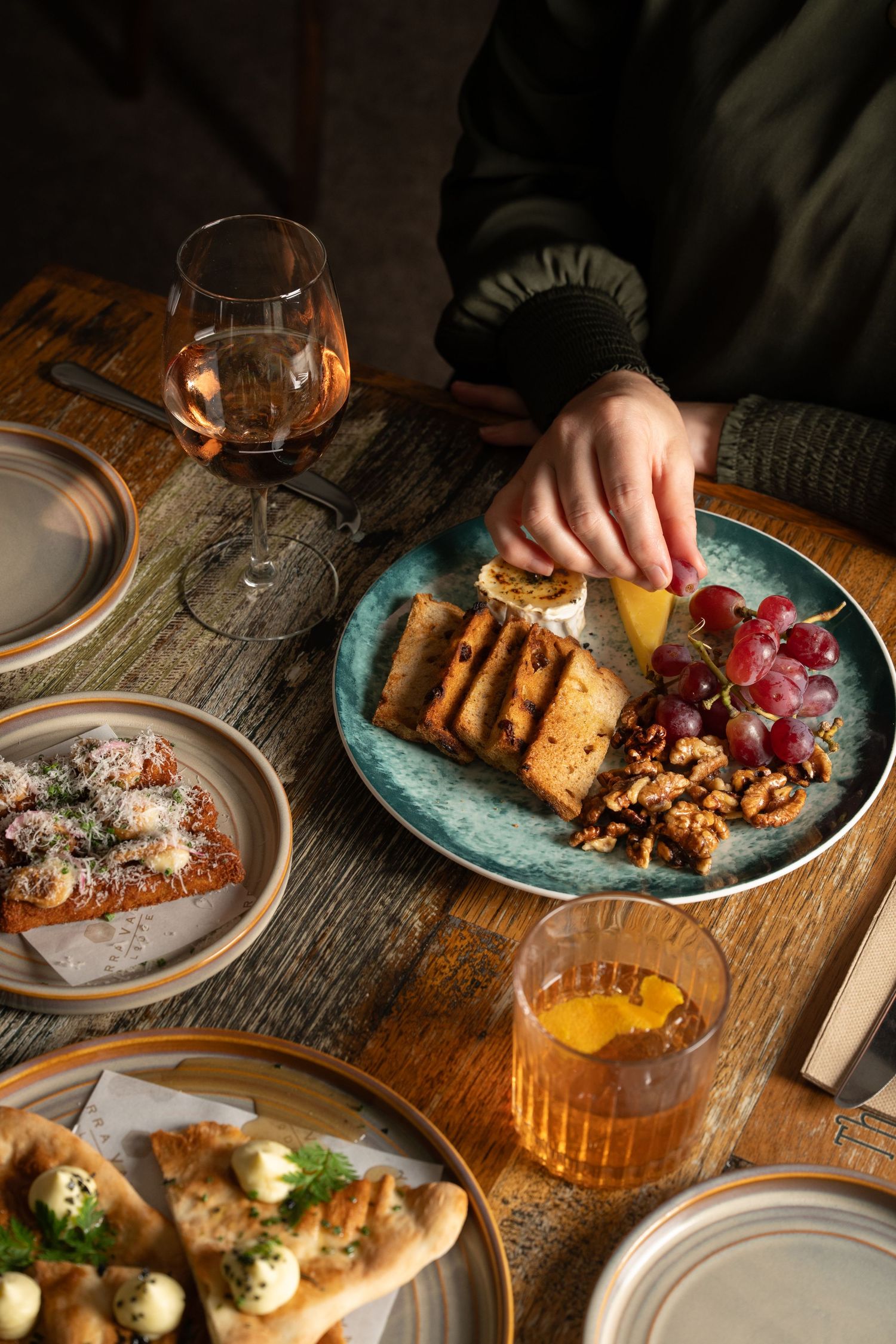 Restaurant food photography capturing shared dining experience and contemporary hospitality atmosphere