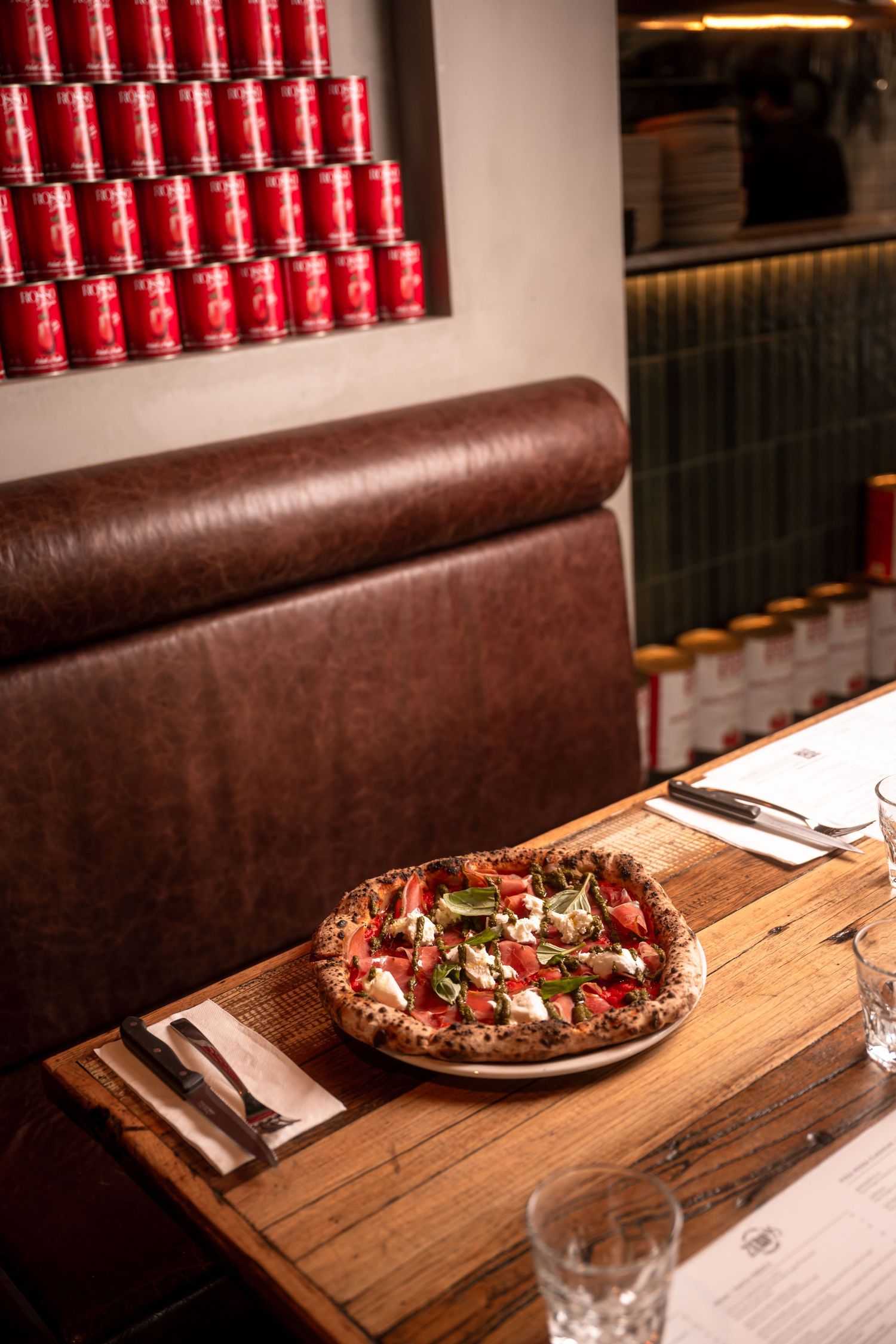 Restaurant food photography showcasing artisan pizza and contemporary Italian dining atmosphere in Melbourne