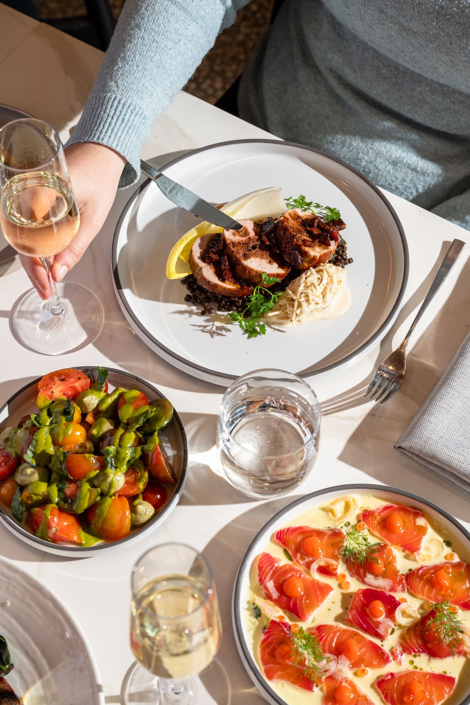 Hospitality photography featuring champagne toast and contemporary restaurant dining atmosphere