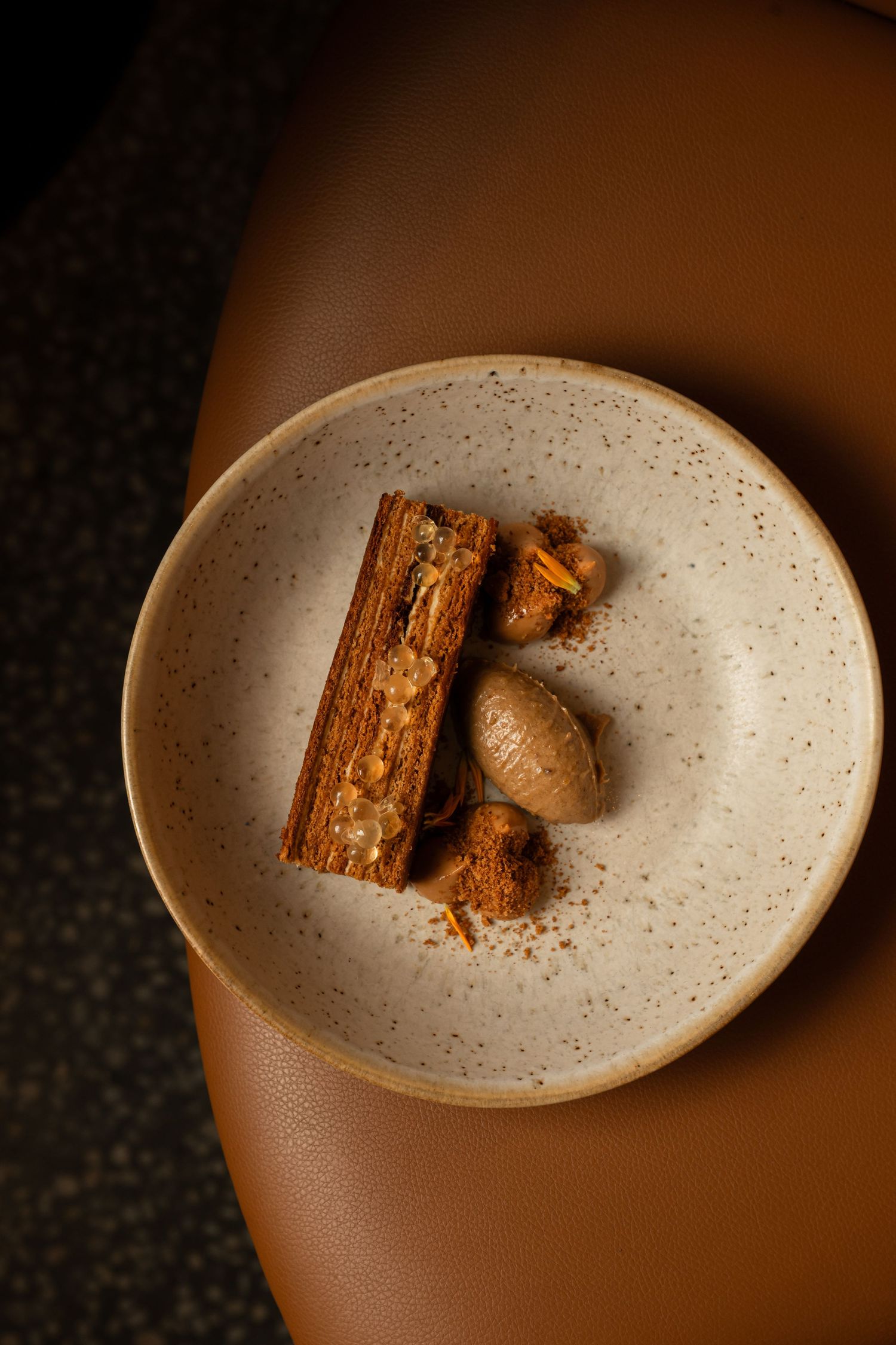 Restaurant food photography showcasing plated dessert with warm lighting and contemporary fine dining presentation
