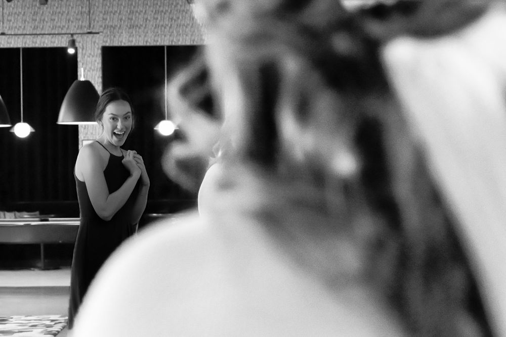 An emotional candid black and white moment captured during a wedding celebration.