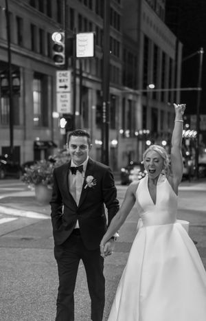 A black and white photo sequence shows a wedding couple playfully running and posing on a city street at night.