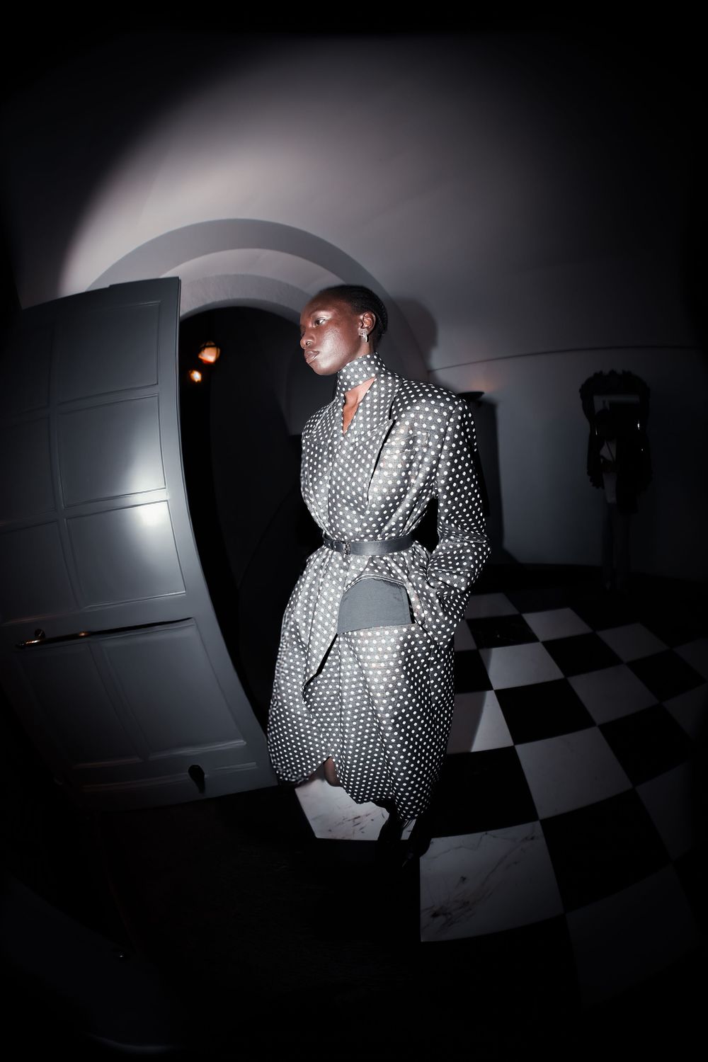 Black and white portrait of model in long textured coat backstage | Editorial Photography by Dario Hudon-Verrelli, Le Café Studio