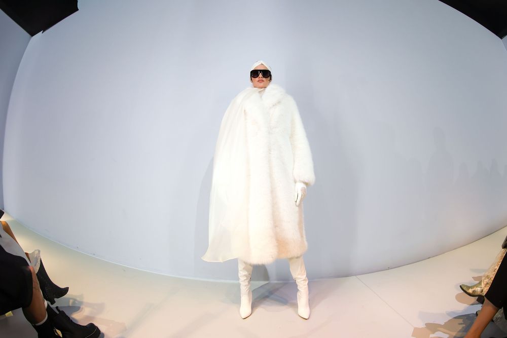 Model in oversized white coat and boots on minimalist runway | Fashion Photography by Dario Hudon-Verrelli, Le Café Studio