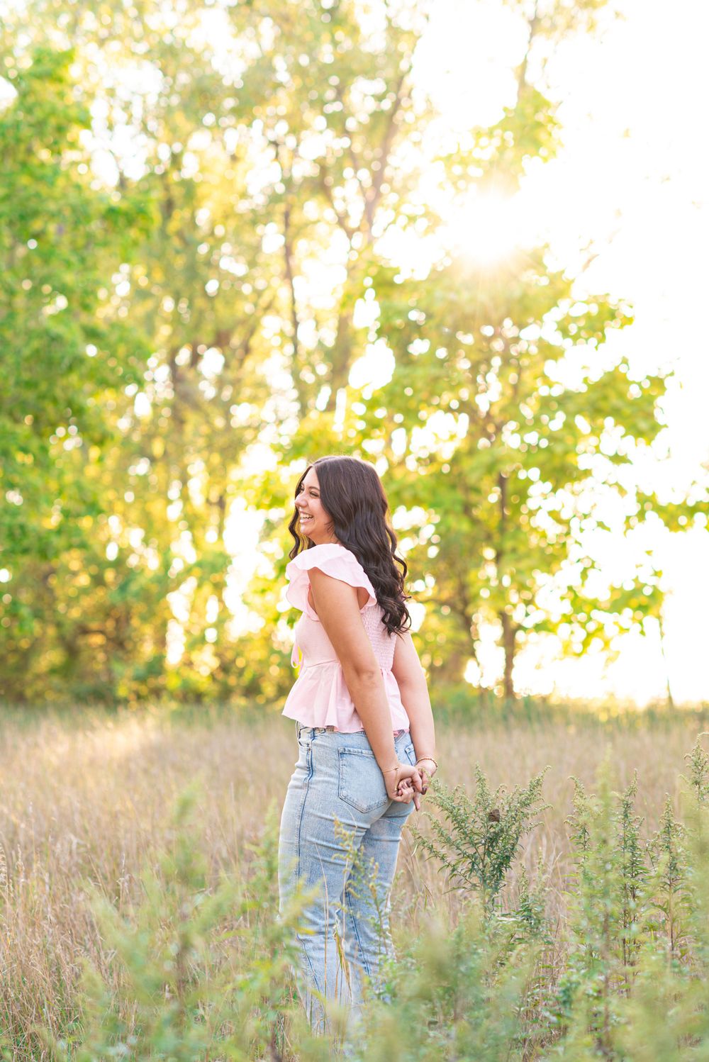 Senior photos standing in a field at Headlands Beach State Park in Mentor, Ohio