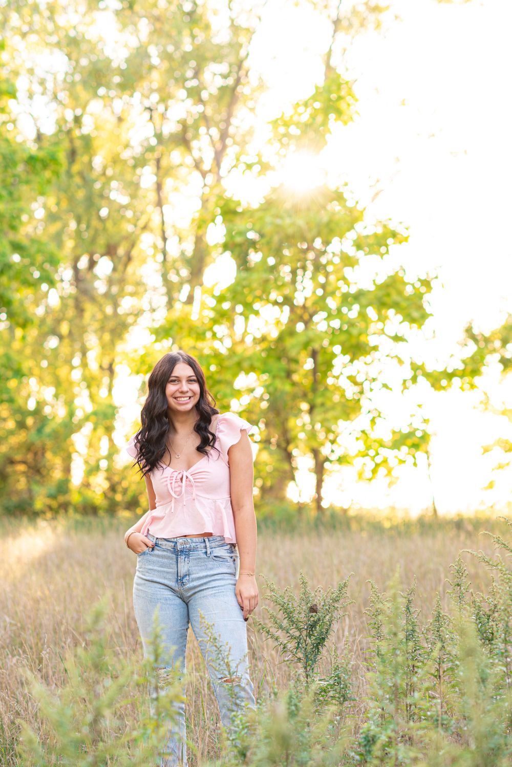 Senior photos standing in a field at Headlands Beach State Park in Mentor, Ohio
