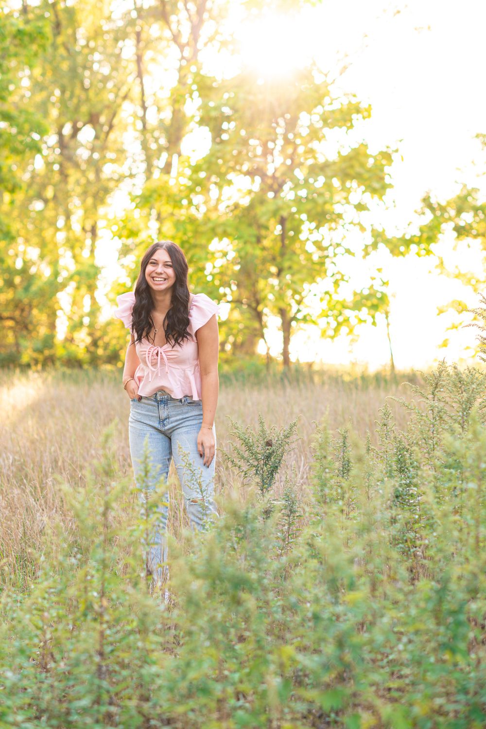 Senior photos standing in a field at Headlands Beach State Park in Mentor, Ohio