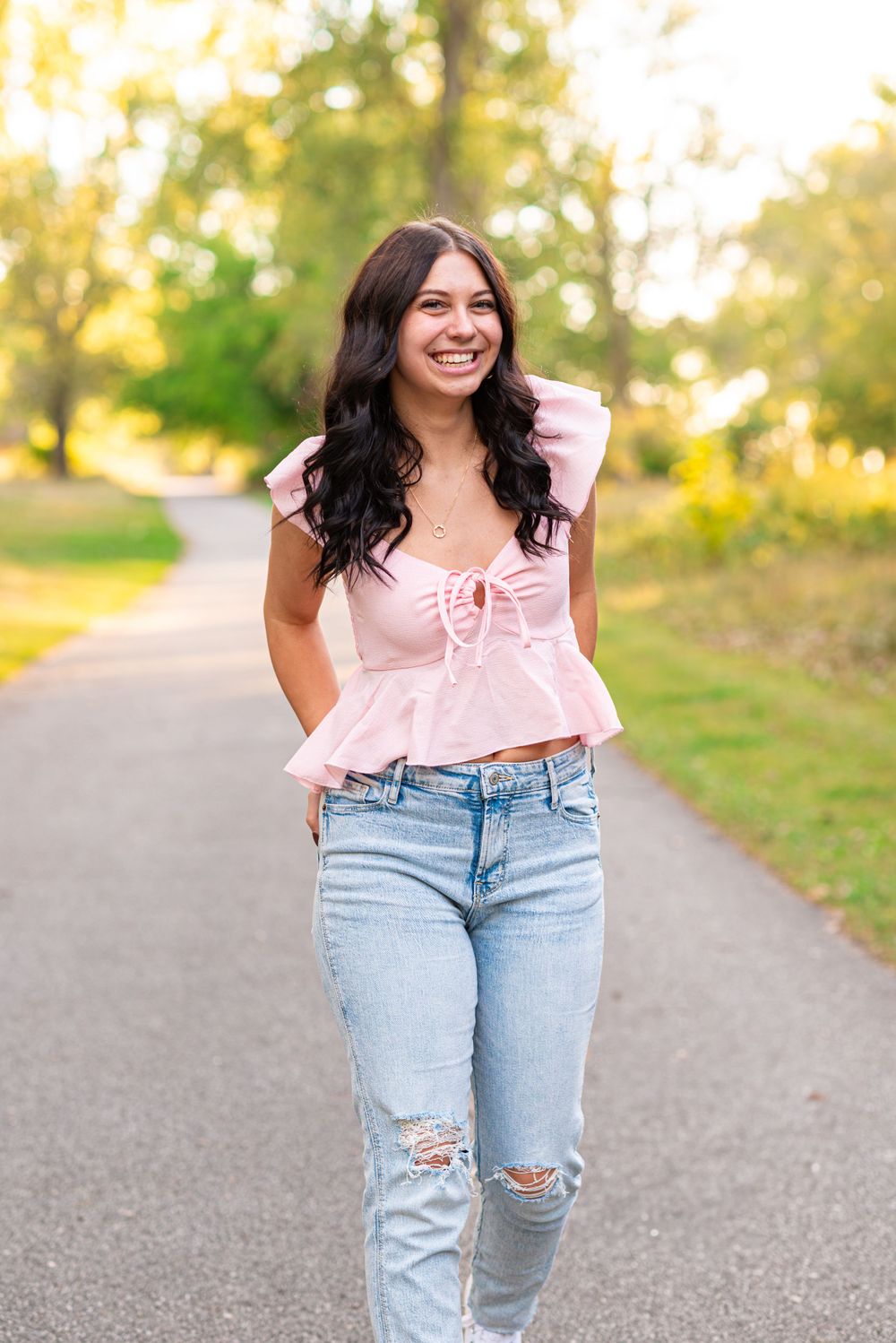 Senior photos walking in the park at Headlands Beach State Park in Mentor, Ohio