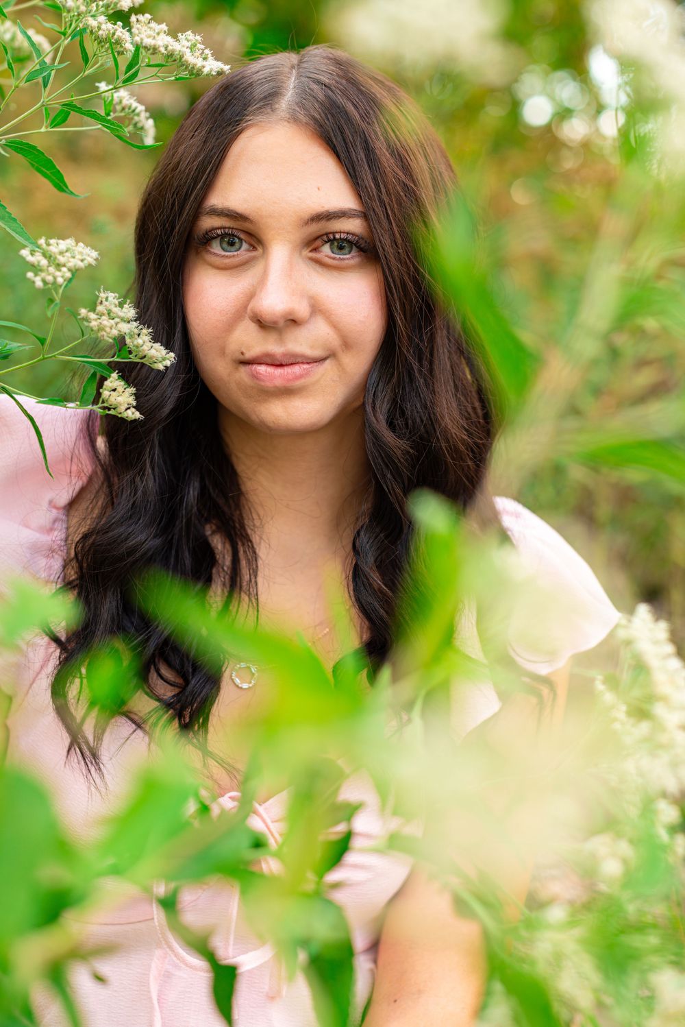 Senior photos sitting in a field at Headlands Beach State Park in Mentor, Ohio