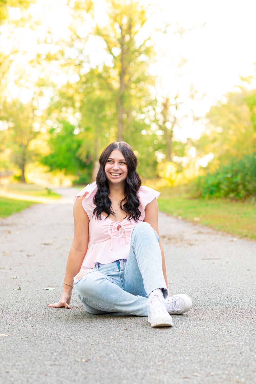 Senior photos sitting in the park at Headlands Beach State Park in Mentor, Ohio