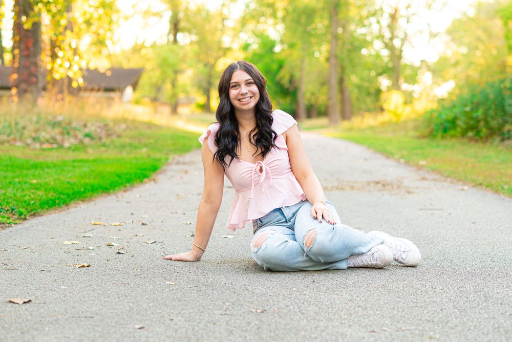 Senior photos sitting in the park at Headlands Beach State Park in Mentor, Ohio