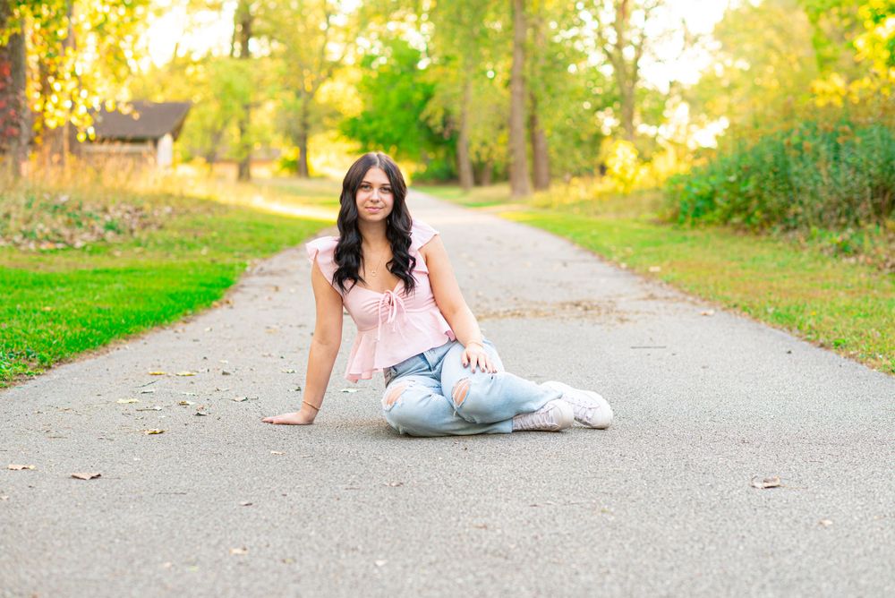 Senior photos sitting in the park at Headlands Beach State Park in Mentor, Ohio