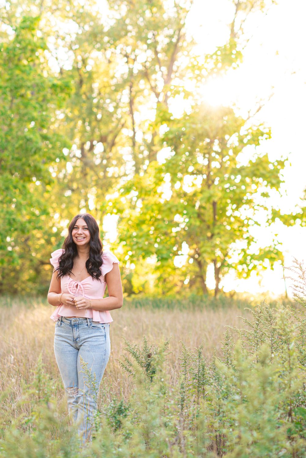 Senior photos standing in a field at Headlands Beach State Park in Mentor, Ohio