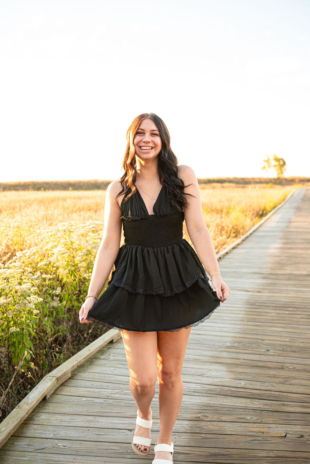 Senior photos walking on the boardwalk at Headlands Beach State Park in Mentor, Ohio
