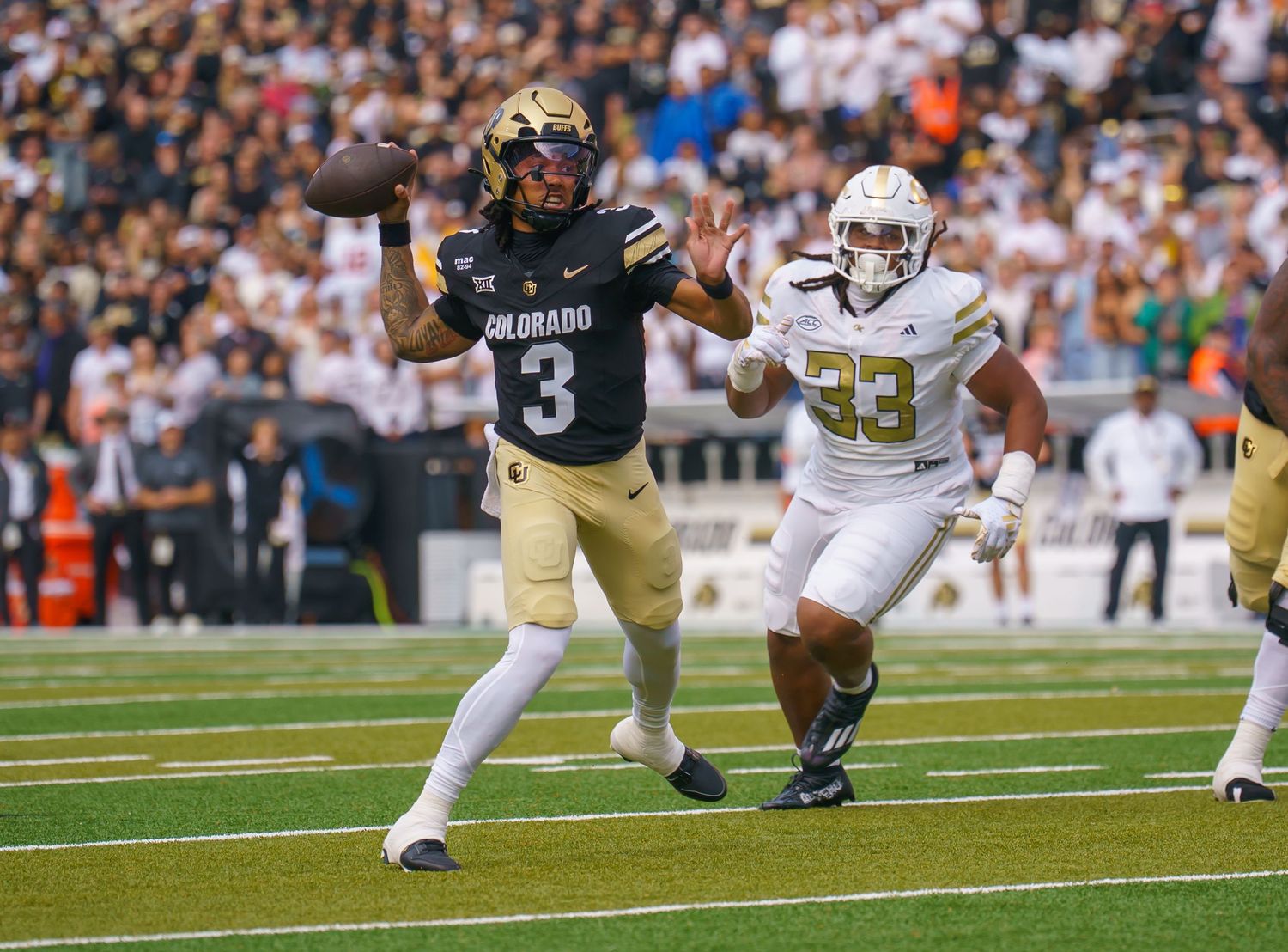 Football player dives forward with the ball during an intense game play on the field.