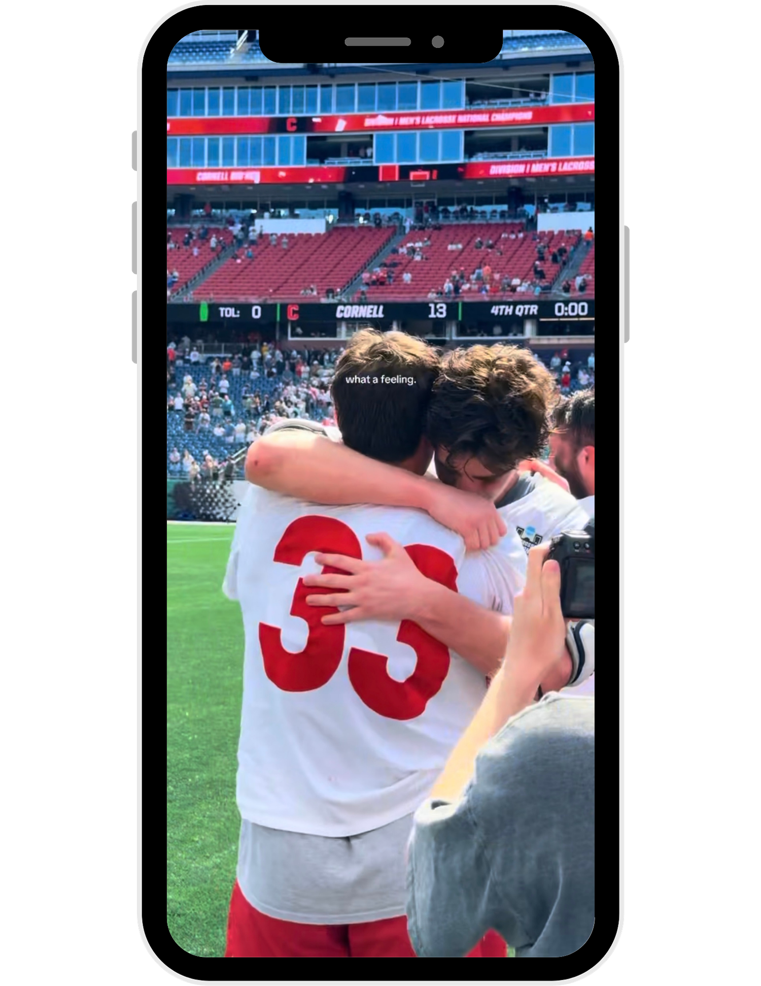 Soccer players in white jerseys celebrate together on the field after a match.
