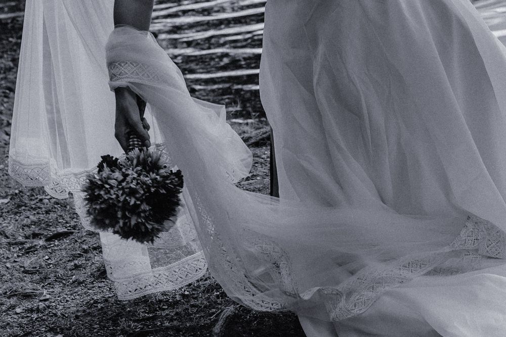 Flowing white fabric creates dramatic movement against a dark background in an artistic composition.