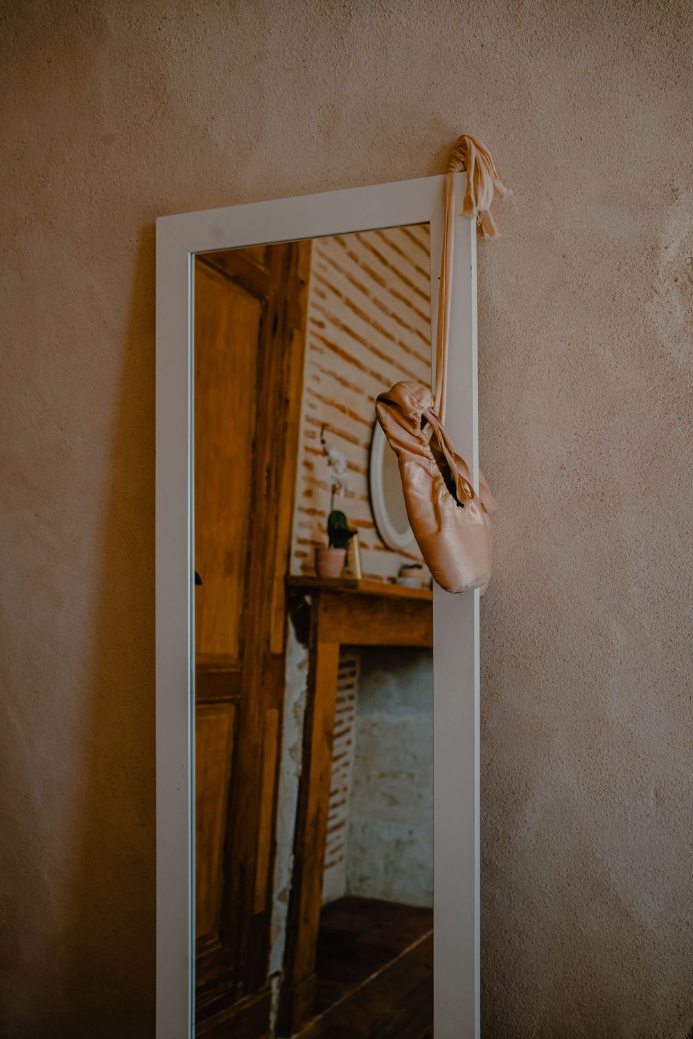 Mirror reflection in rustic wooden interior with soft natural lighting.