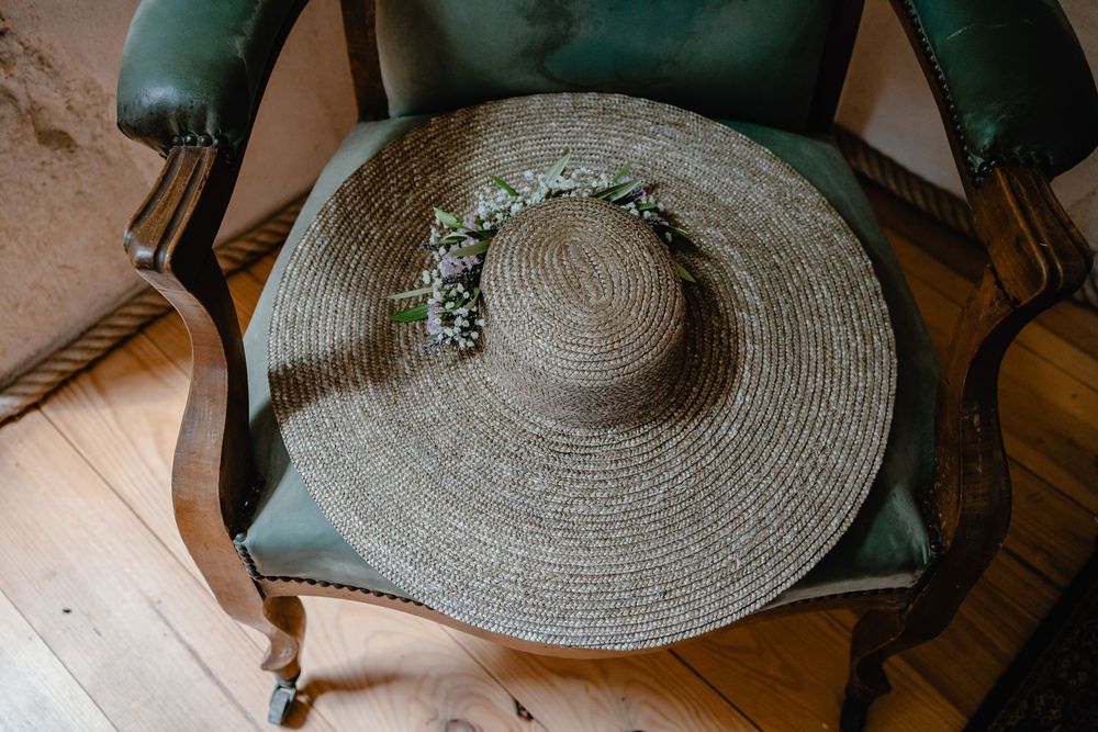 Vintage straw hat with floral details photographed from above.