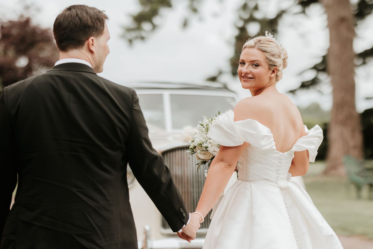 A bride and groom share a romantic moment outdoors during their wedding photo session.