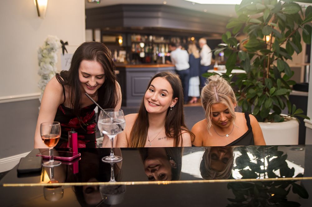 Group of people enjoying drinks and conversation at a social gathering.