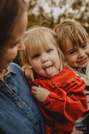 Close up candid photos of children playing and making silly faces while wearing red and denim clothing.