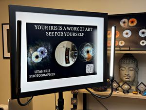 Black and white photo gallery wall displays framed artwork and text with vinyl records as decorative accents.