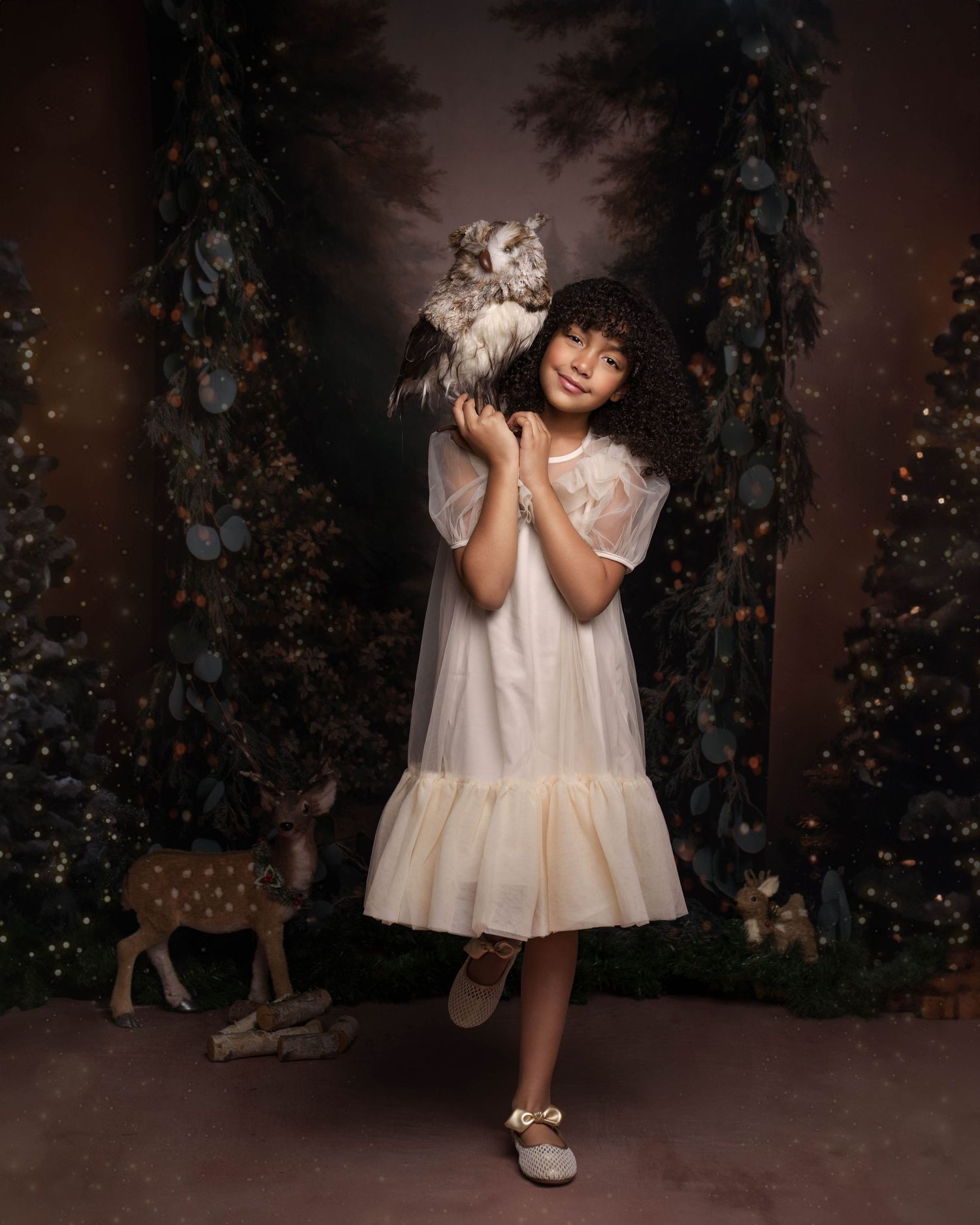 A series of holiday portraits showing a small child in a white dress posing playfully against a dark backdrop with Christmas trees.
