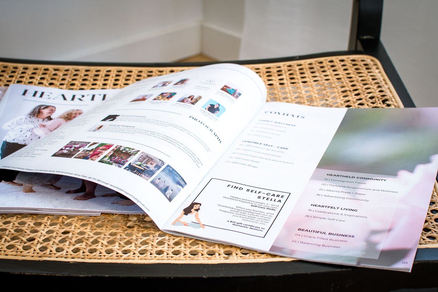 Magazine spread open on woven rattan surface showing editorial layouts and images.