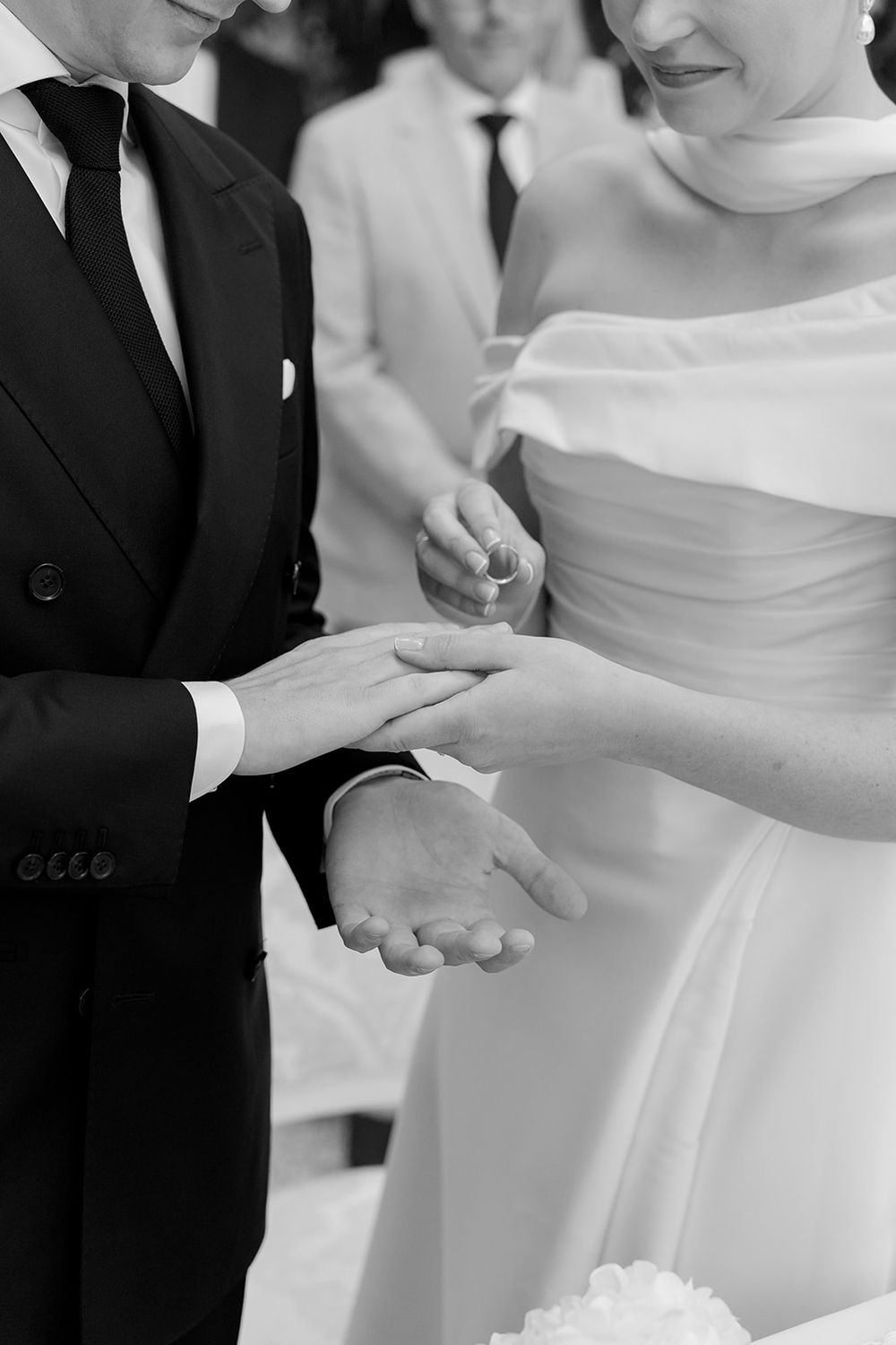 Close-up view of hands during a wedding ceremony as rings are exchanged.